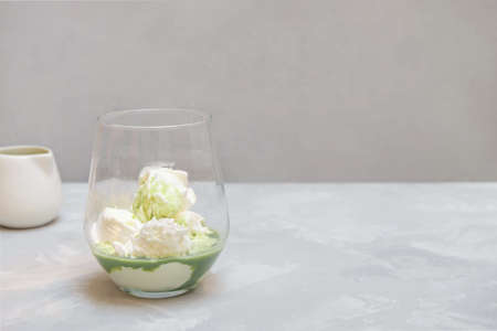 Matcha (green tea) affogato dessert on neutral grey background with copy spaceの写真素材