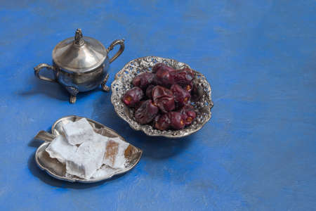 Ramadan sweet food, dates and lokum on blue backgroundの写真素材