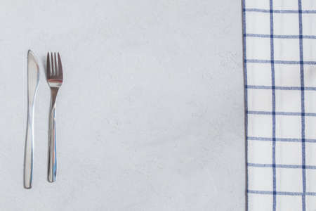 Top view of silverware and table cloth on neutral table background. Image with copy spaceの写真素材