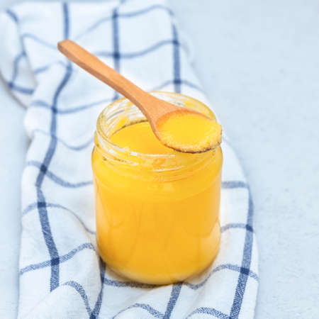 Indian ghee (clarified butter) with wooden spoon