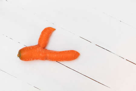 Ugly carrot shows thumbs up in support of food waste trendの写真素材