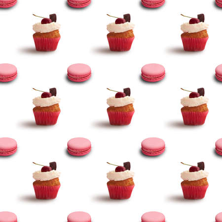 Delicious sweet pastry seamless background with pink macaroons and cupcakesの写真素材