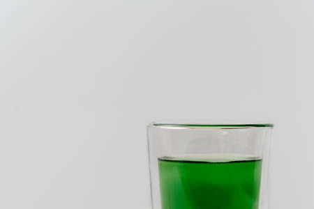 Healthy drink liquid chlorophyll extract with cup of water on white background with copy spaceの写真素材
