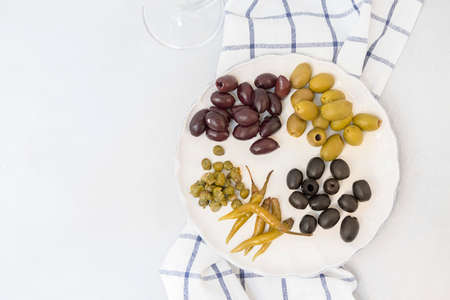 Italian antipasti, different types of olives, capers, peppers Mediterranean assortment of delicious...