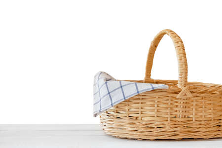 Isolated empty wicker basket on white wooden table. Template mock up for product displayの写真素材
