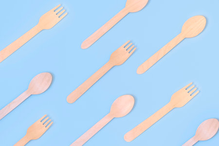 Top view of eco-friendly spoon and fork on light blue background. Zero waste, eco friendly, plastic free background.の写真素材