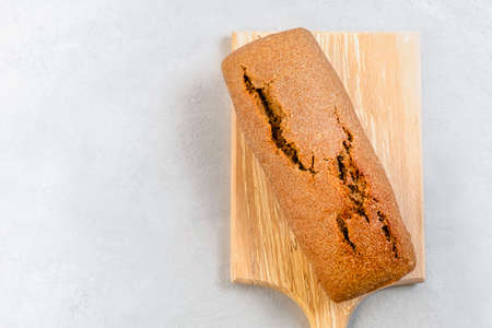 Top view of freshly baked sourdough bread on neutral background with copy space