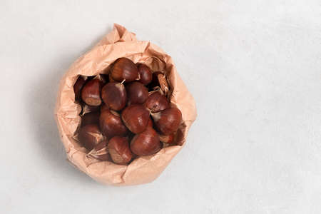 Top view of fresh chestnuts on neutral grey background with copy spaceの写真素材