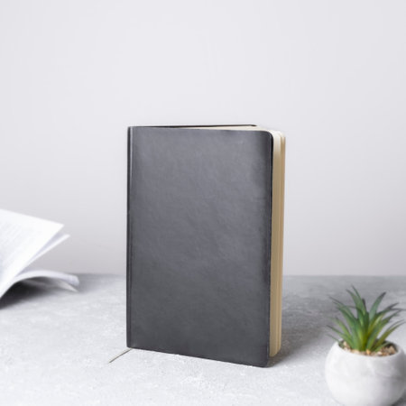 Black book mockup with workspace accessories. Front view. Place for text, copy space, mockup