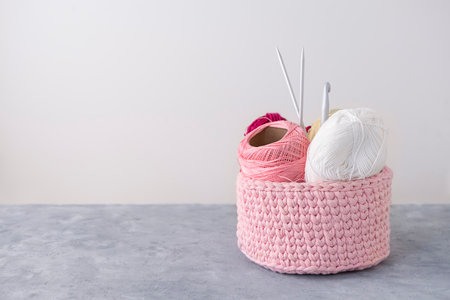 Crochet basket with handcraft tools for knitting and crocheting with copy spaceの写真素材