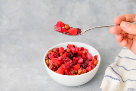 Fork with vinaigrette salad on neutral background, copy spaceの写真素材