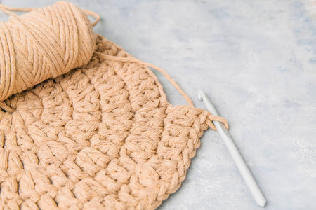 Closeup of carpet made with cord yarn using double crochet (treble crochet) stiches, copy space
