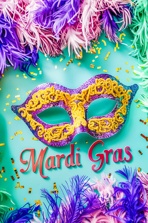 Text Mardi Gras on pastel green background with confetti and carnival maskの素材