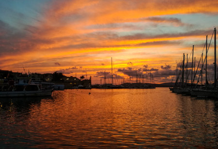 Sunset over the sea at the harbor of Alghero - Sardinia (Italy)の写真素材