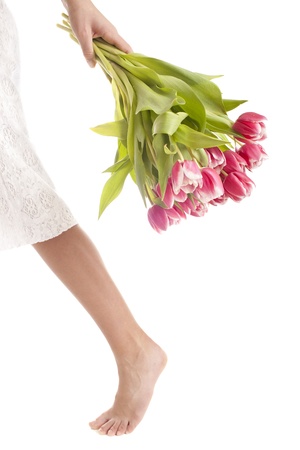 woman legs whithout shoes with flowers, isolated on a whiteの写真素材