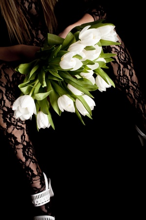 woman legs  in white shoes with flowers, isolated on a blackの写真素材