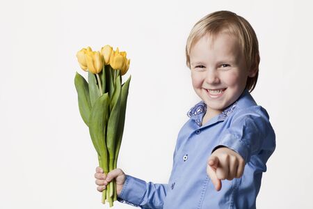 positive 5 years old boy with flower