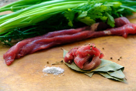  Raw meat with herbs and spices on wooden boardの写真素材
