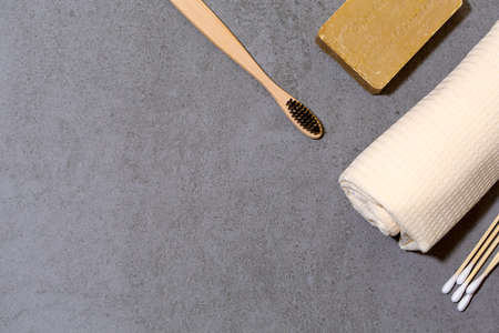 Zero waste tools for personal hygiene. Eco toothbrush, olive soap, cotton towel and cotton swaps. Free space for text.の写真素材