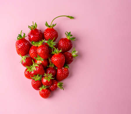 Strawberries on pink background. Top view.の写真素材