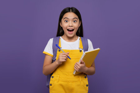 Excited Schoolgirl with Backpack and Notebookの素材