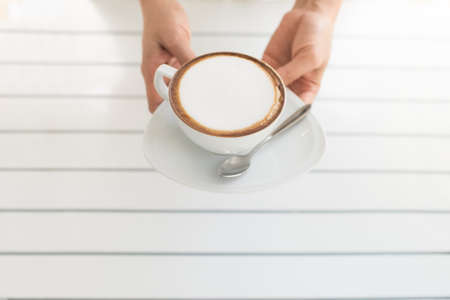 vintage girl drinking cappuccino coffee at cageの写真素材