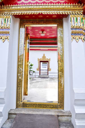 Beautifully decorated doorway entrance to buddhist temple in Thailandの写真素材