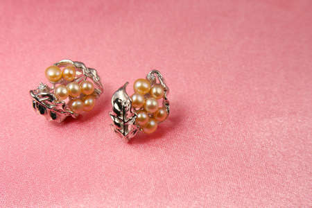 Jewelry pearl presents on pink silk backgroundの写真素材