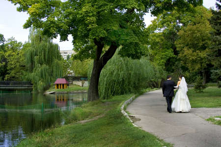Bride and groom in wedding day in a parkの写真素材