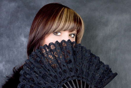 Charming young woman with italian fan. Fashion studio portraitの写真素材