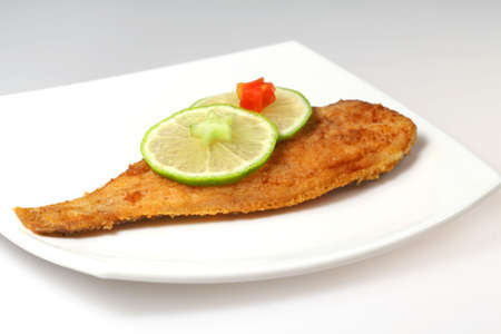 Roasted  Flounder ( plaice ) on a plate with limeの写真素材