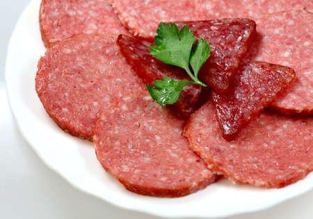 Assortment of summer and  smoked  sausage on a plate