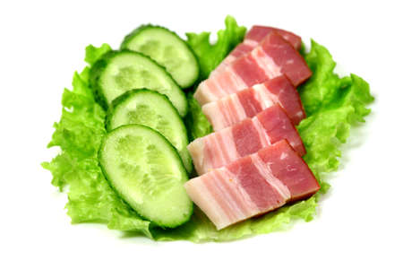 Bacon and green cucumber on lettuce
