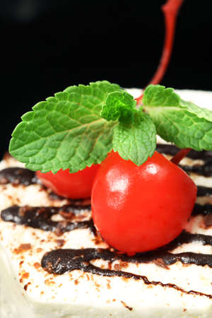  Tasty baking celebratory fancy cake with cherry  and green mint