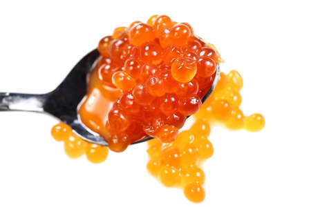Salmon caviar on spoon isolated over white backgroundの写真素材
