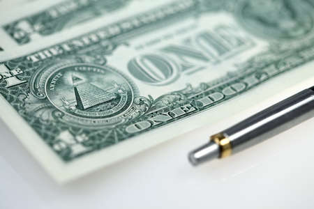 The American money dollars. Bundle of bank notes and penの写真素材