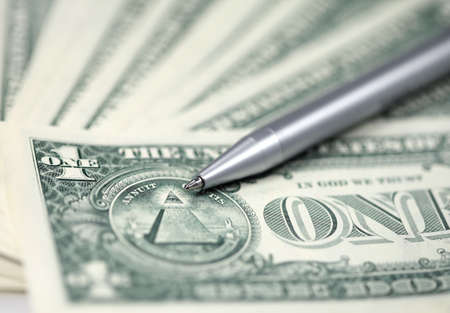 The American money dollars. Bundle of bank notes and penの写真素材