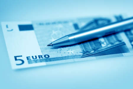 The money euro. Bundle of bank notes  and pen in blue colorの写真素材