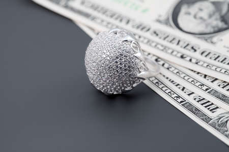  American dollars. Bundle of bank notes and brilliant ringの写真素材