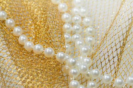 Christmas fine decorations -  beads on golden netの写真素材