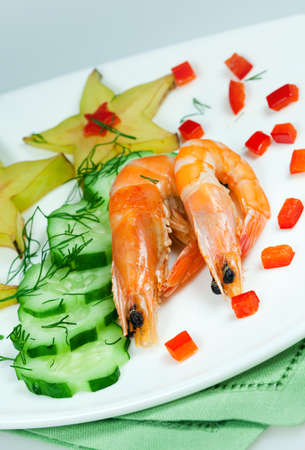 Salad of vegetables avocado with shrimp, decoration carambola for supperの写真素材