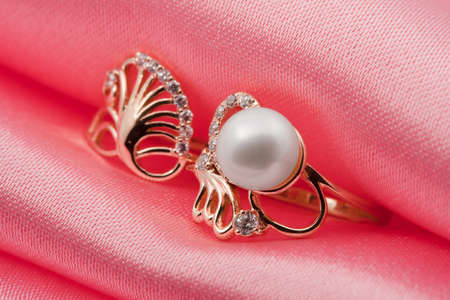  Elegant jewelry ring with jewel stone on a background of pink silkの写真素材