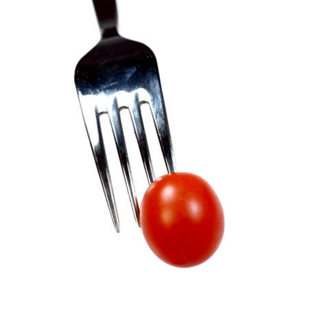  Cherry tomato on a steel fork isolated over whiteの写真素材