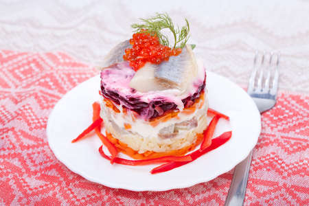 Salad of  fish herring and red caviar  for snack  の写真素材