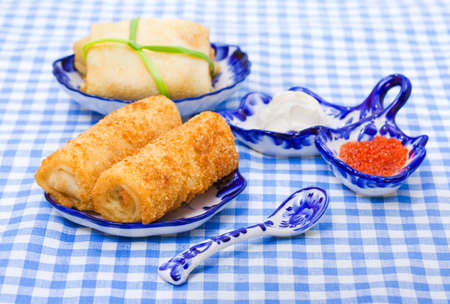 Food - plate with russian snack - pancakes and salmon red caviar on a tableの写真素材