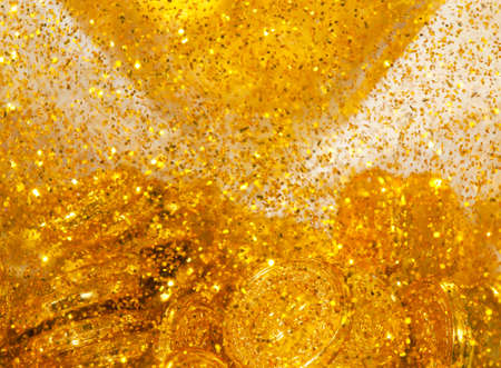 Golen coins and goldy sand, natural textureの写真素材