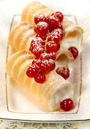 Tasty  dessert with waffle roll and  Red currant  