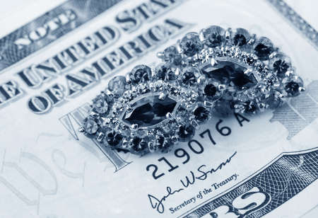 American dollars and jewelry   Bundle of bank notes and brilliant ringの写真素材