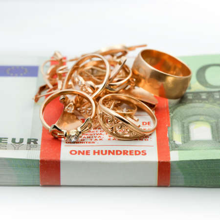 Jewelry and banknotes money on white backgroundの写真素材