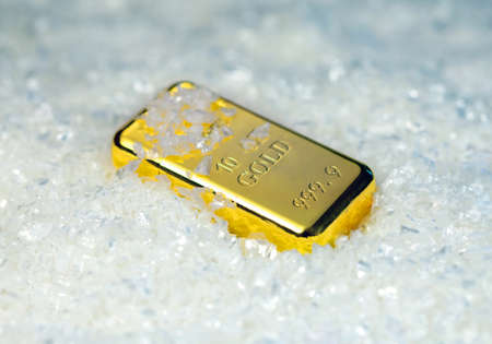 Gold bullion  on snowy background
